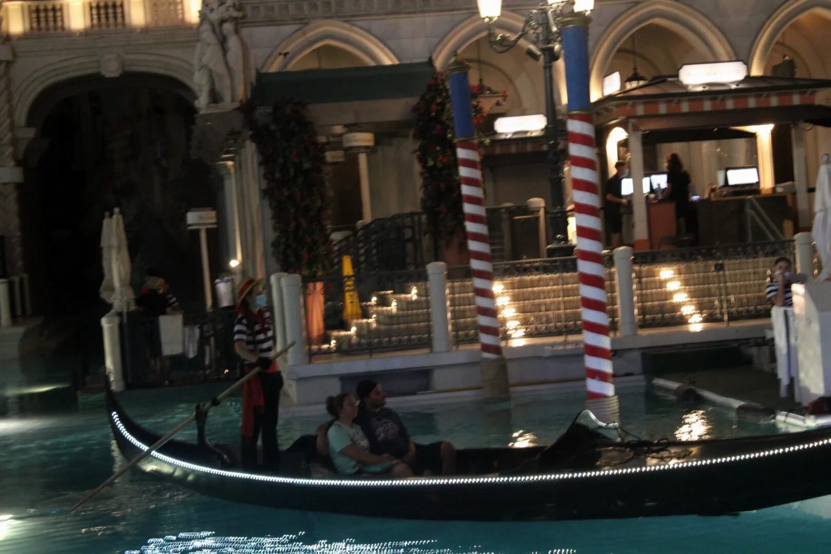 A gondola is in the water near some buildings.