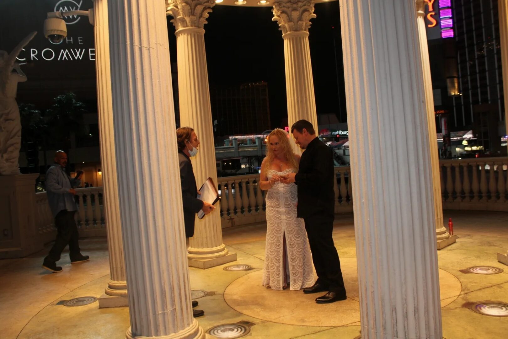 A couple is standing in front of pillars